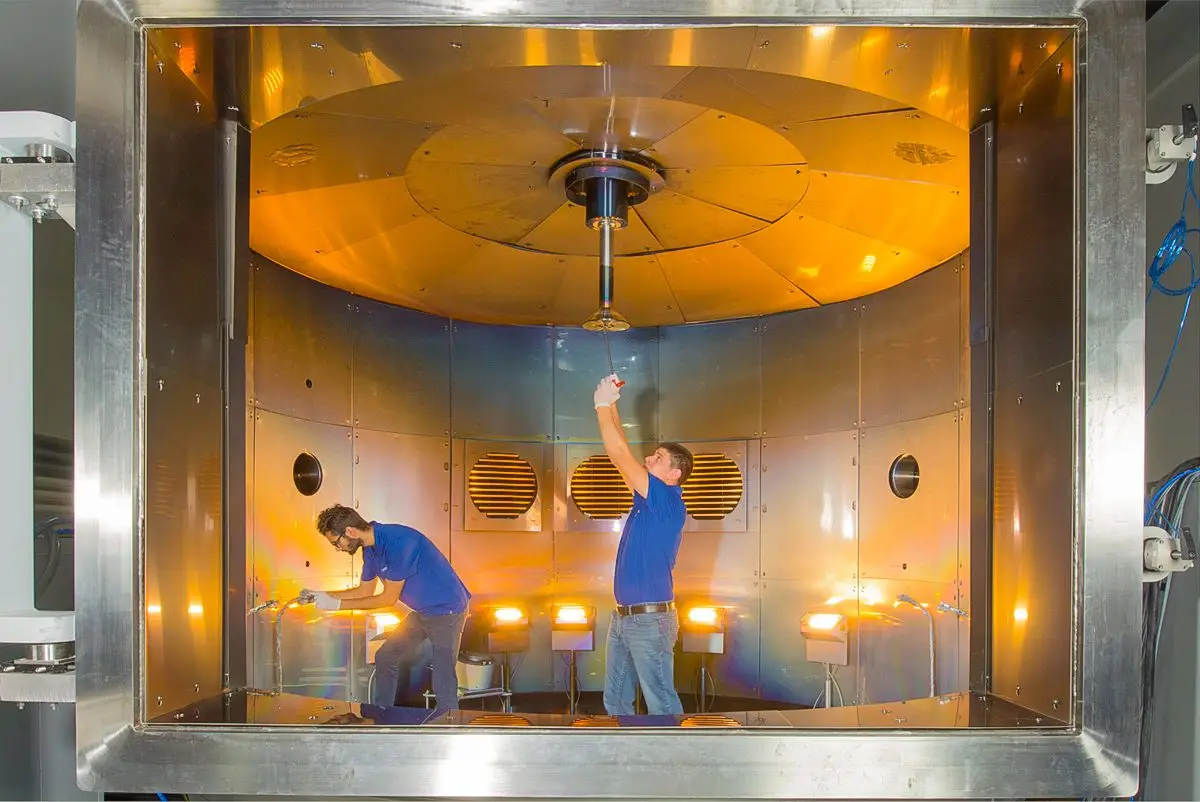 inside of the tecport symphony 36 thin film vacuum deposition chamber with two employees working inside the chamberinside of the symphony 36 thin film vacuum deposition chamber with two employees working inside the chamber